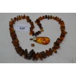 An amber necklace, and an amber pendant (2)