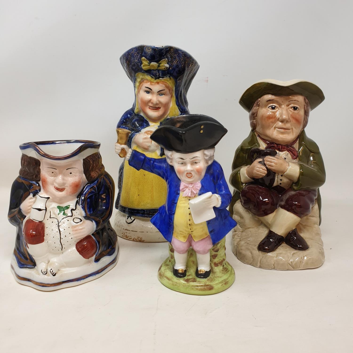 A Staffordshire pottery Town Crier character jug, 16 cm high, and three other character jugs (4)