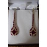 A pair of platinum Art Deco style drop earrings set with rubies and diamonds