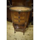 A French oval stand, with floral and chinoisery marquetry, the brass gallery above three drawers, on