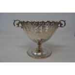 A silver pedestal bowl, with a pierced border and scroll handles, Birmingham 1929, approx. 11.4 ozt,