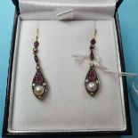 A pair of drop earrings set with rubies, diamonds and pearls