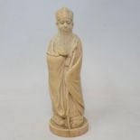 An early 20th century Chinese carved ivory figure, of a sage holding a staff, 19 cm high
