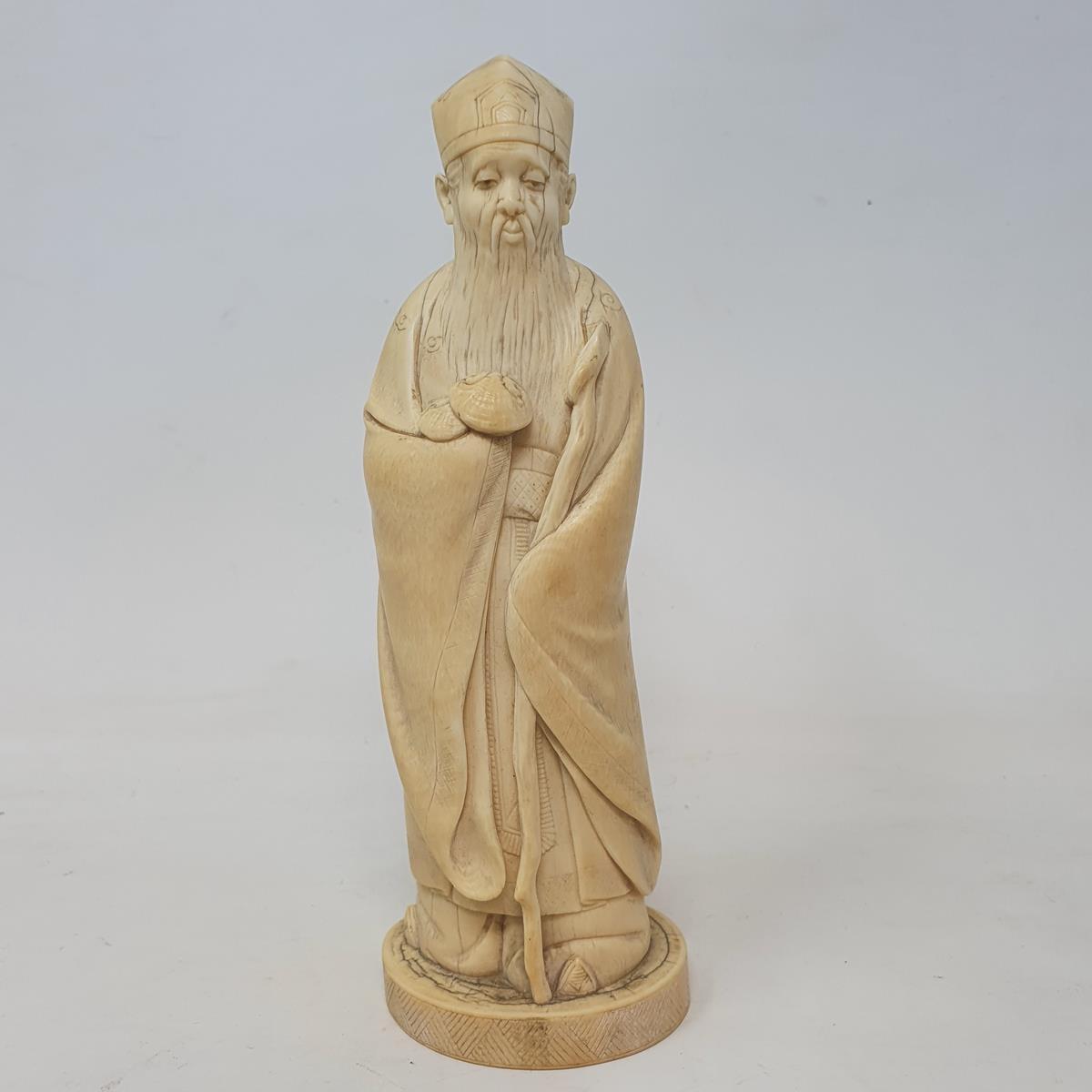 An early 20th century Chinese carved ivory figure, of a sage holding a staff, 19 cm high - Image 3 of 21