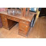 A mahogany pedestal desk, having an arrangement of nine drawers, 122 cm wide