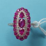 An 18ct gold, ruby and diamond flowerhead ring