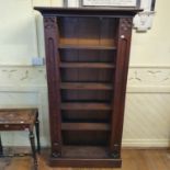 A Gothic style oak bookcase, the columns hinged to open pigeon holes, on a plinth base, 105 cm wide