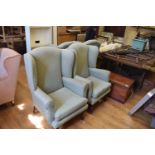 A set of four wing back armchairs on mahogany cabriole legs