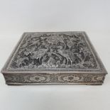 An Indian silver coloured metal box, the cover embossed birds and foliage, 16.5 cm wide