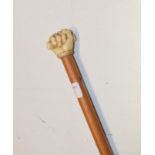 A 19th century mallacca cane, the finial carved as a clenched fist, length 81 cm