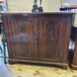 A mahogany cabinet, with a pair of panel doors, on bracket feet, 111 cm wide
