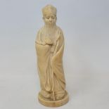 An early 20th century Chinese carved ivory figure, of a sage holding a staff, 19 cm high