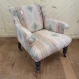 A late Victorian upholstered armchair, on turned front legs