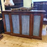 A breakfront mahogany bookcase/cabinet, having two pairs of doors with brass grilles, 192 cm wide