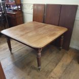 An early 19th century mahogany extending dining table, inset three extra leaves, on tapering