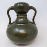 A Chinese green glazed pottery double gourd vase, with twin handles, 19 cm high generally good, a