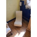 A nursing chair, an oak armchair and a footstool, an afghan style rug
