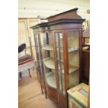 An Edwardian inlaid mahogany serpentine front display cabinet, on tapering square legs with spade