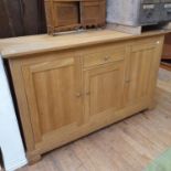 An oak cabinet, with a drawer and three cupboards, 161 cm wide