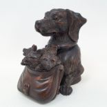 A Black Forest style carved wood box and cover, in the form of a dog with a satchel full of puppies,