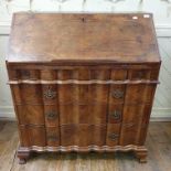 An 18th century Continental walnut bureau, the fall front revealing a fitted interior and a well,