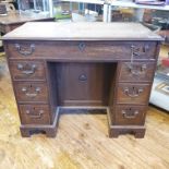 A 19th century mahogany kneehole desk, having an arrangement of seven drawers and a cupboard, 99