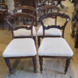 A set of four early Victorian rosewood dining chairs, the backs carved acanthus leaves, on
