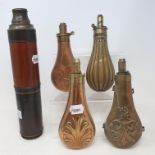 A 19th century mahogany and brass three draw telescope, five copper and brass powder flasks, a