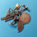 A group of early 20th century yellow coloured metal masonic charms to include moon, star, hammer,