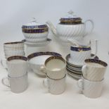 A late 18th century porcelain part tea service, with a horizontal blue band with gilt decoration,