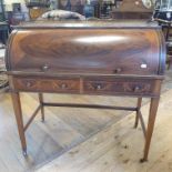 An Edwardian cylinder desk, with a brass three quarter gallery back, a cylinder section and with two