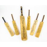 A group of miniature cricket bats including two signed by the 1974 West Indies cricket team (6)