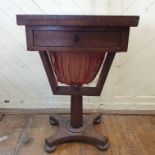 An early Victorian rosewood games/work table, on an octagonal tapering column and concave sided