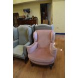 A George III style wing back armchair and another