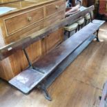 A late Victorian/Edwardian pine and iron tram bench, 273 cm