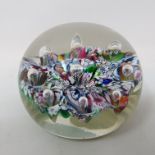 A Paul Ysart glass paperweight, the scrambled multi coloured cane ground with inset bubbles, applied