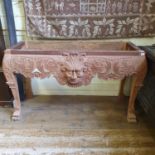 A stand, in the 18th century taste, carved a face mask and foliage, 29 cm wide By RB Back rail