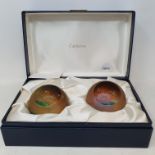 A pair of Caithness glass paperweights, Alpha & Omega set, designed by Colin Terris, limited edition