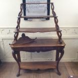 A 19th century Continental walnut bookcase/shelf unit, having three graduated tiers on a base with a