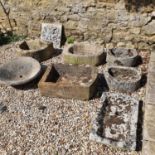 A stone D-shaped trough, repaired, 72 cm wide, six reconstituted stone troughs/planters, and a Green