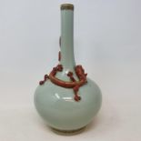 A Chinese celadon ground bottle vase, with a slender neck, applied a Chilong dragon with gilt