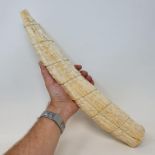 A late19th/early 20th century Congolese ivory tusk, carved figures in a procession, 44 cm cracks