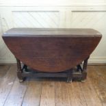 An 18th century oak gateleg table, on tapering turned legs, 137 cm wide