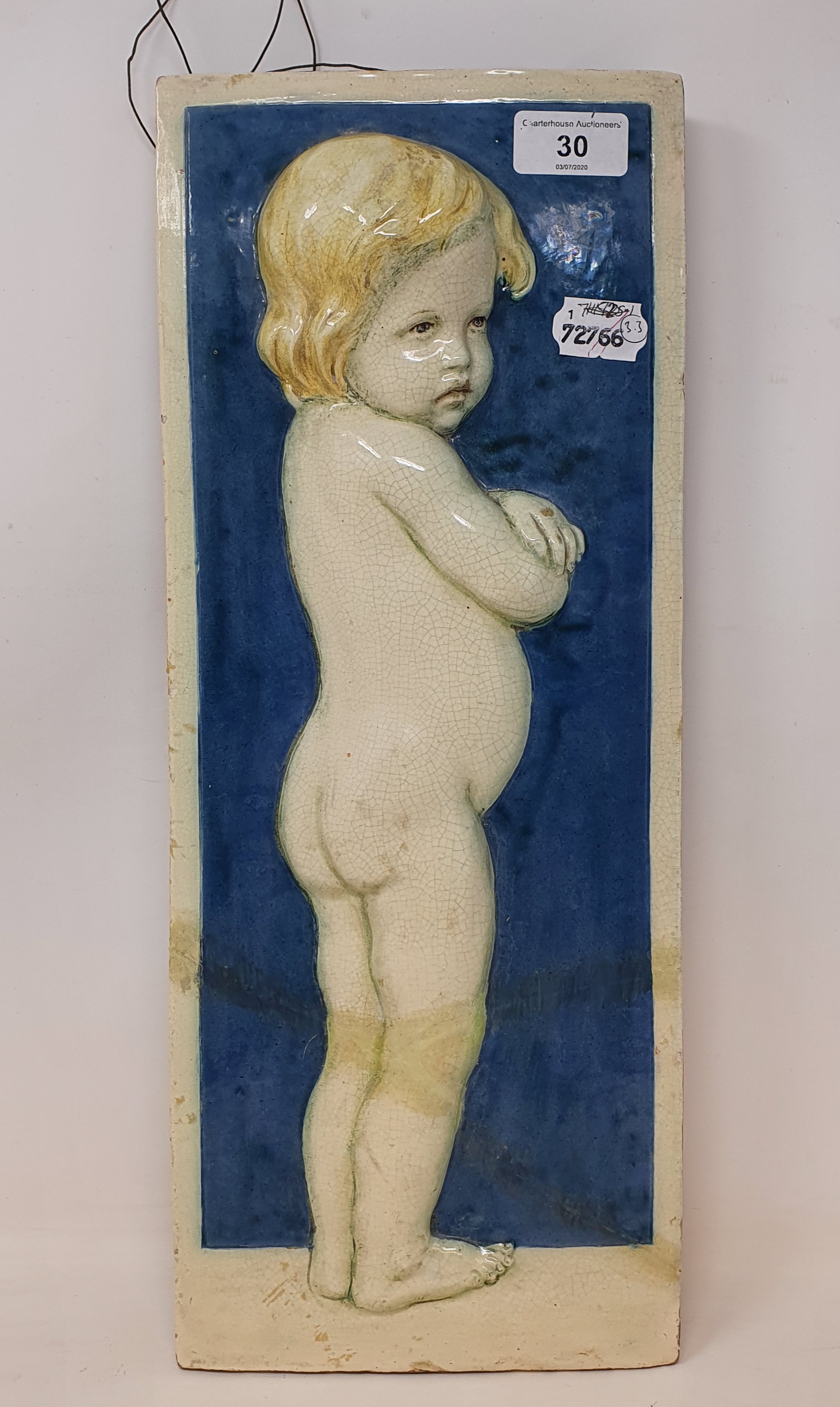 A Della Robia pottery plaque, decorated a child, signed in script D (painted ship) R 14 Morte (?) C,