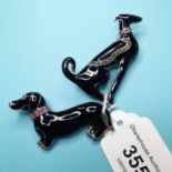 An Art Deco style black enamel dog brooch, and another similar (2)