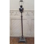 A late Victorian brass floor standing lamp, with a corinthian column