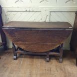 An 18th century oak gateleg table, on barley twist legs joined by stretchers, 134 cm wide