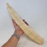 A late19th/early 20th century Congolese ivory tusk, carved figures in a procession, 44 cm cracks