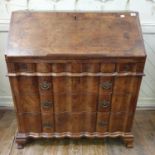 An 18th century Continental walnut bureau, the fall front revealing a fitted interior and a well,