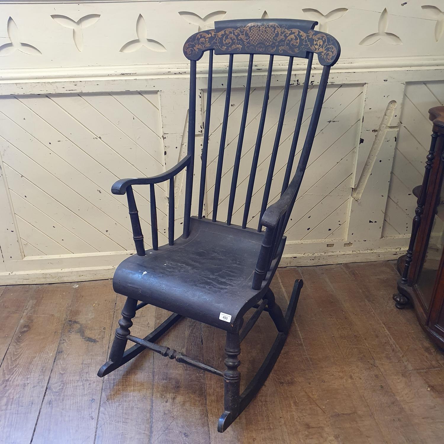 A painted rocking armchair, the crest rail with gilt decoration